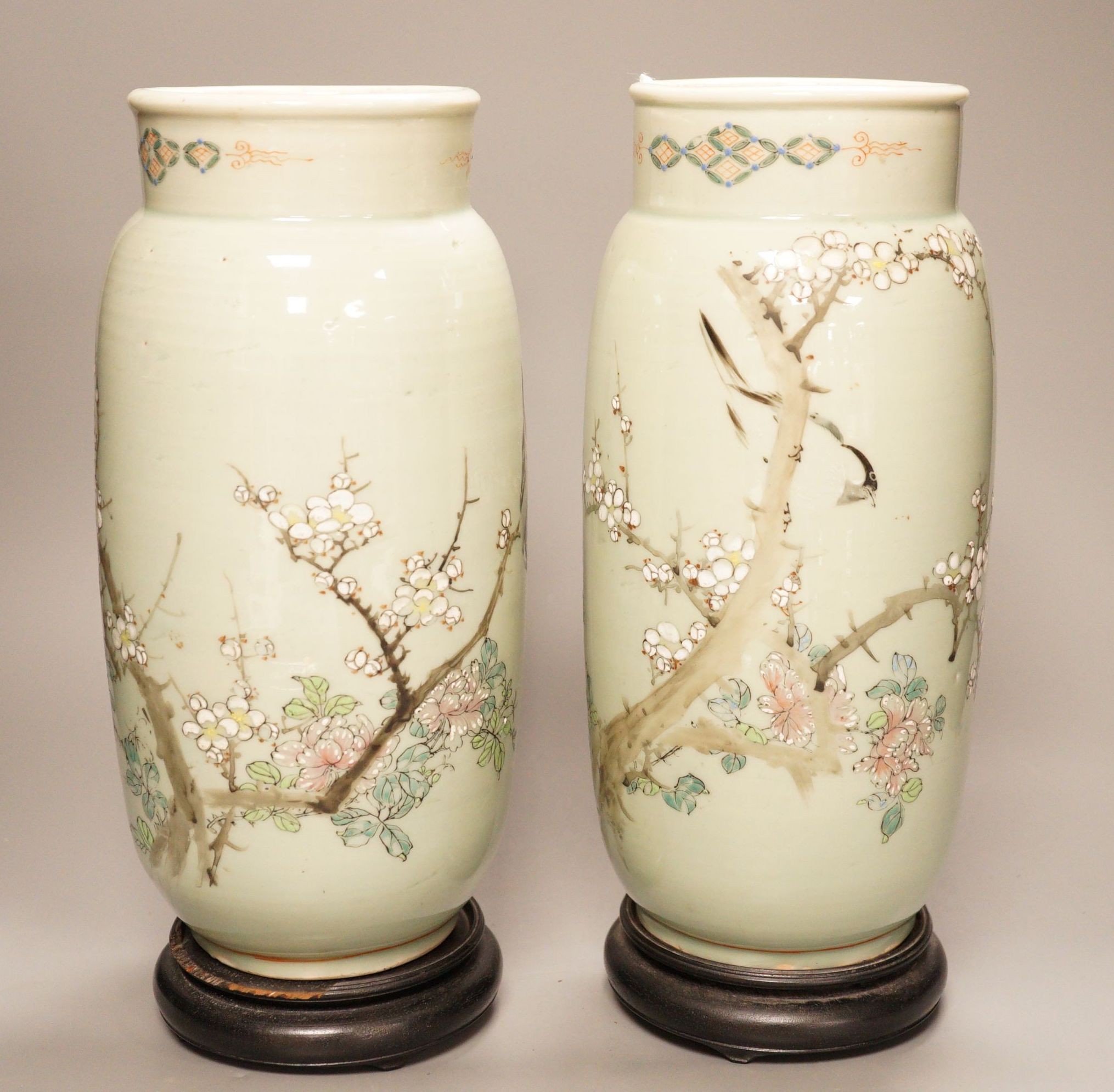 A pair of 19th century Japanese celadon glazed vases (drilled) with hardwood stands, total height 31cm